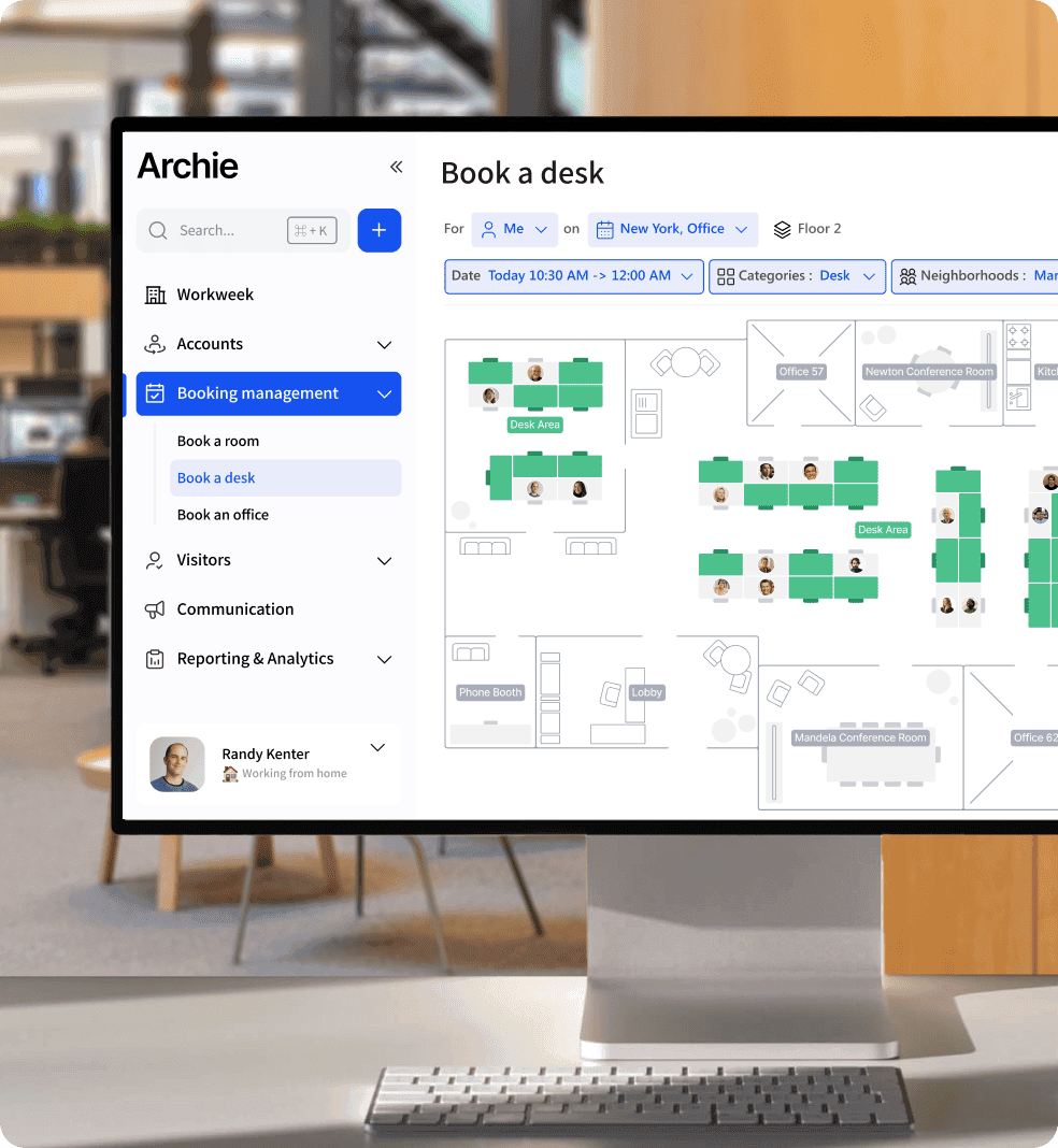 Desktop monitor showing Archie “Book a desk” floor plan in open-plan office space.
