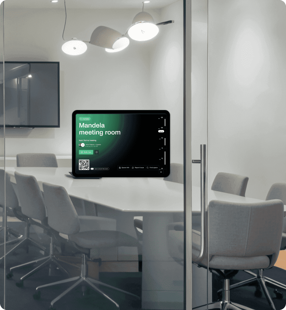 Glass-walled conference room with tablet outside showing green “Mandela meeting room” status screen.
