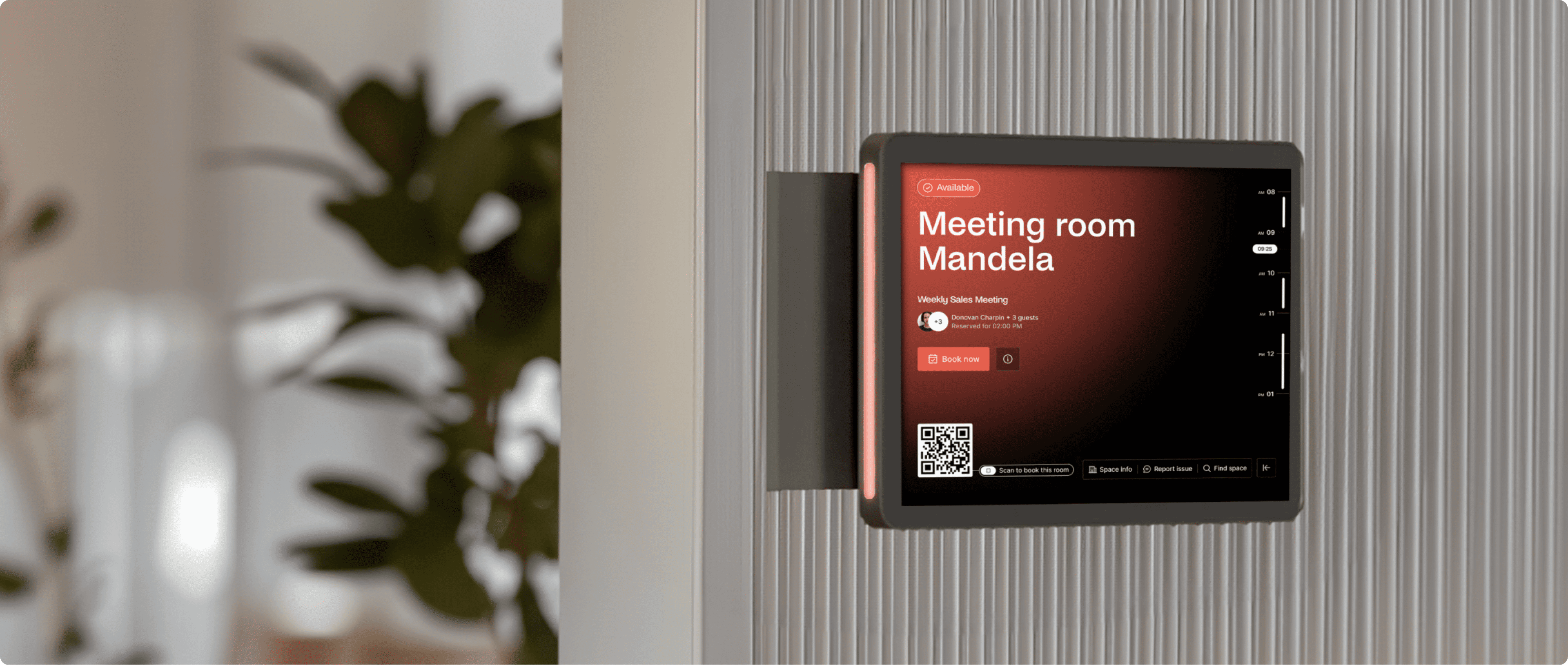 Tablet outside meeting room “Mandela” displaying red booking interface with QR code, flanked by plants.