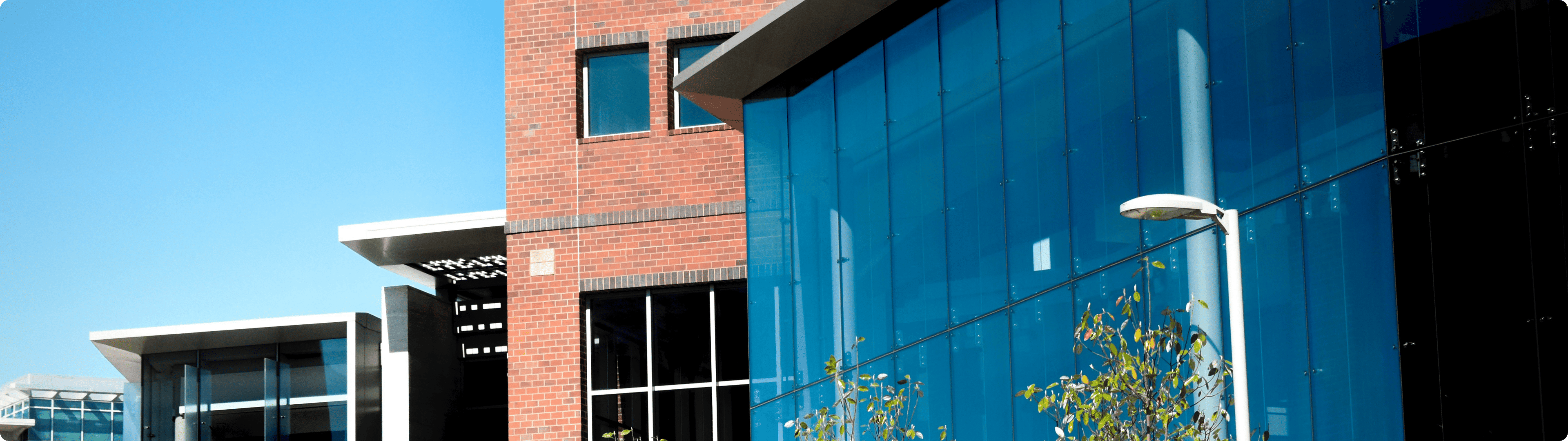 Contemporary government or civic building with brick and glass architecture, blue sky background