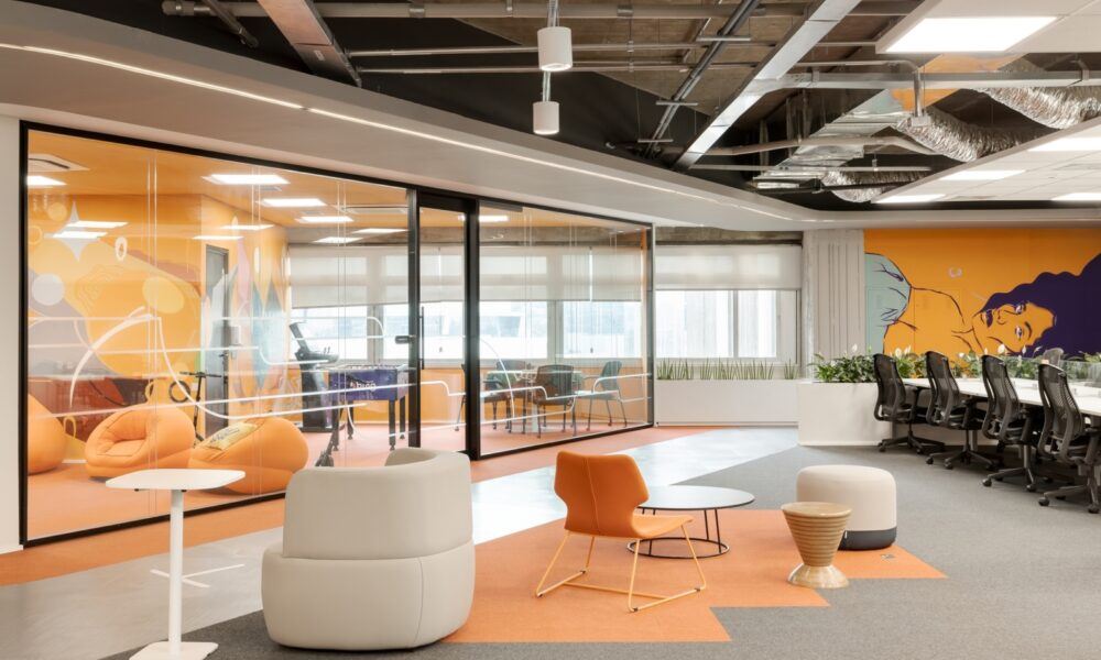 modern hybrid workplace with orange decor
