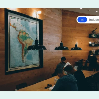 A cozy coworking space with wooden walls, warm lighting, and a large map of South America.