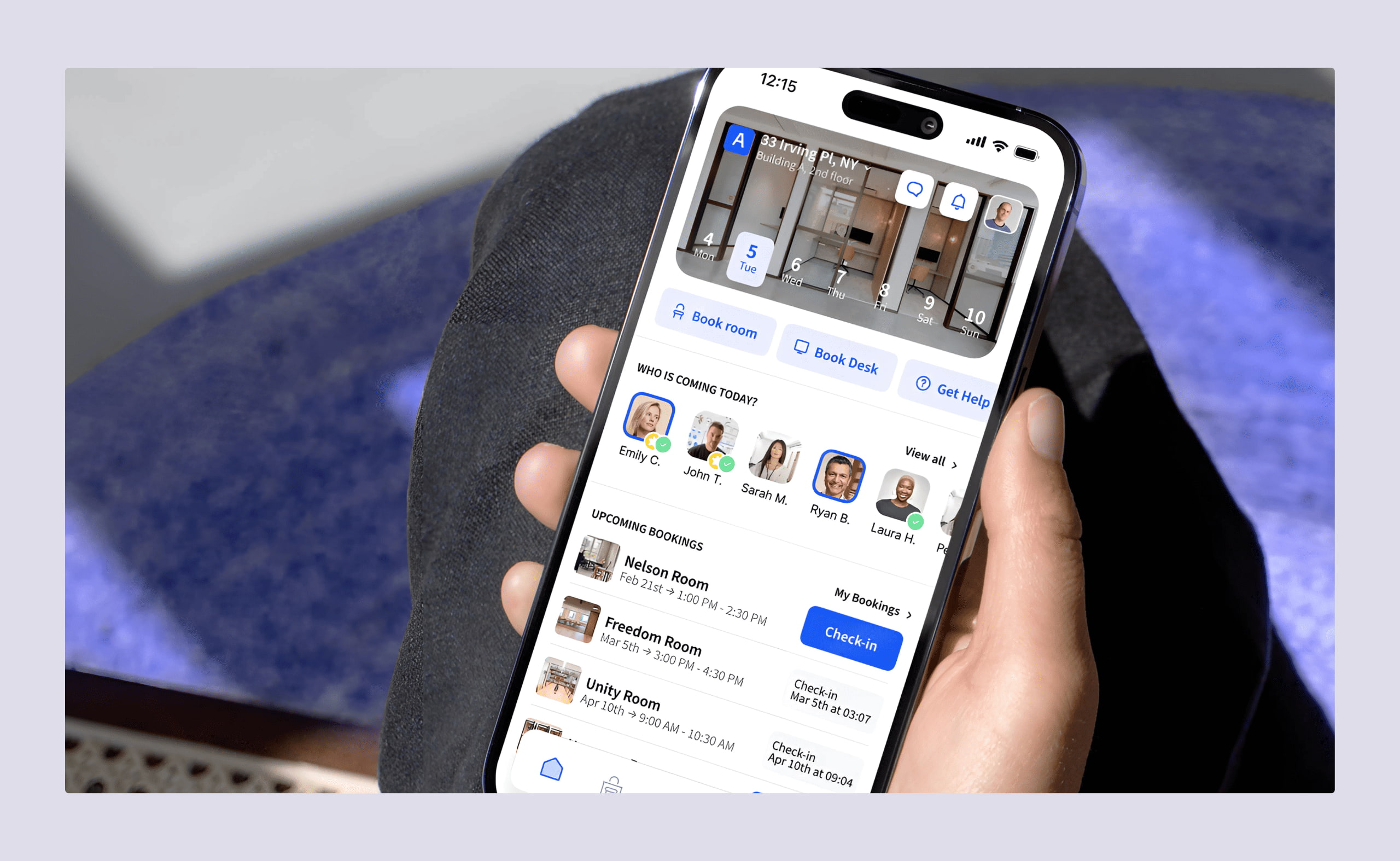 Hand holding a smartphone showing the Archie app interface with desk and room booking options.