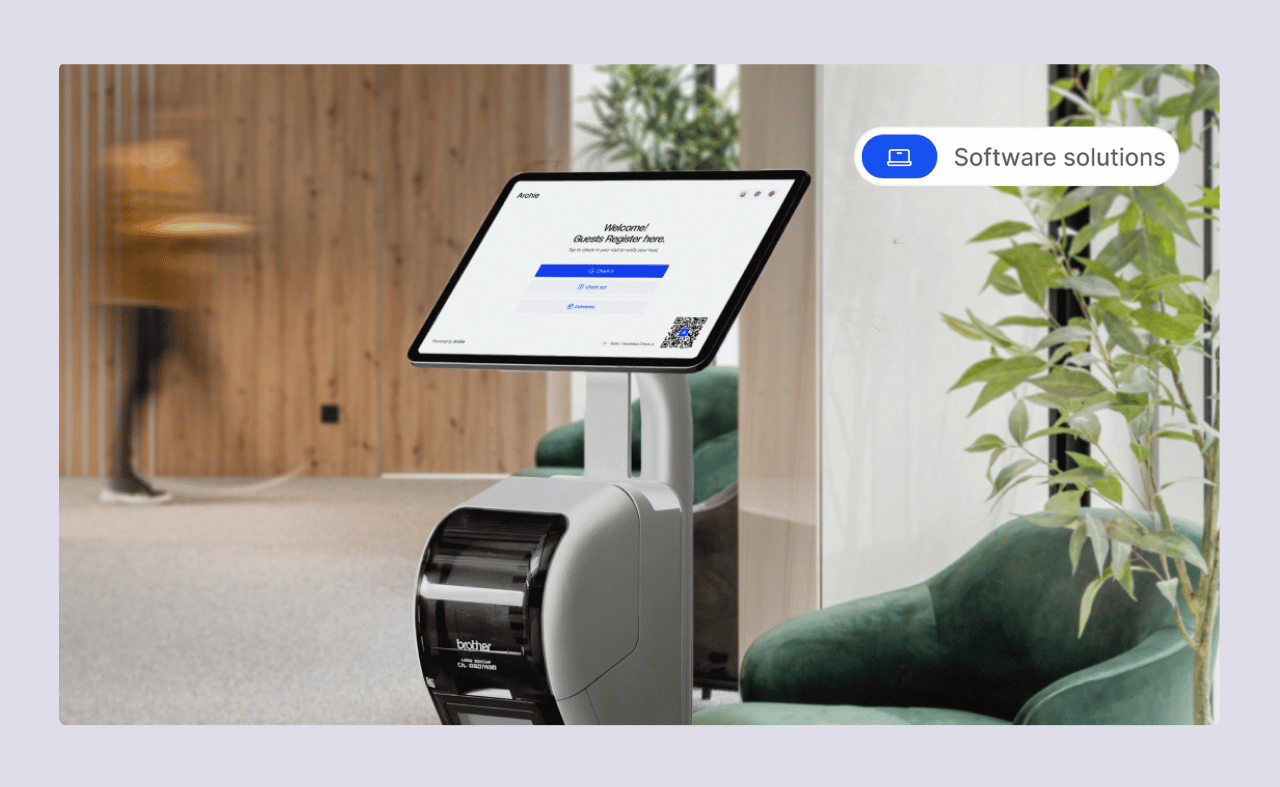 Archie's digital check-in kiosk with a touchscreen and badge printer set up in a modern office lobby, displaying a guest registration form.