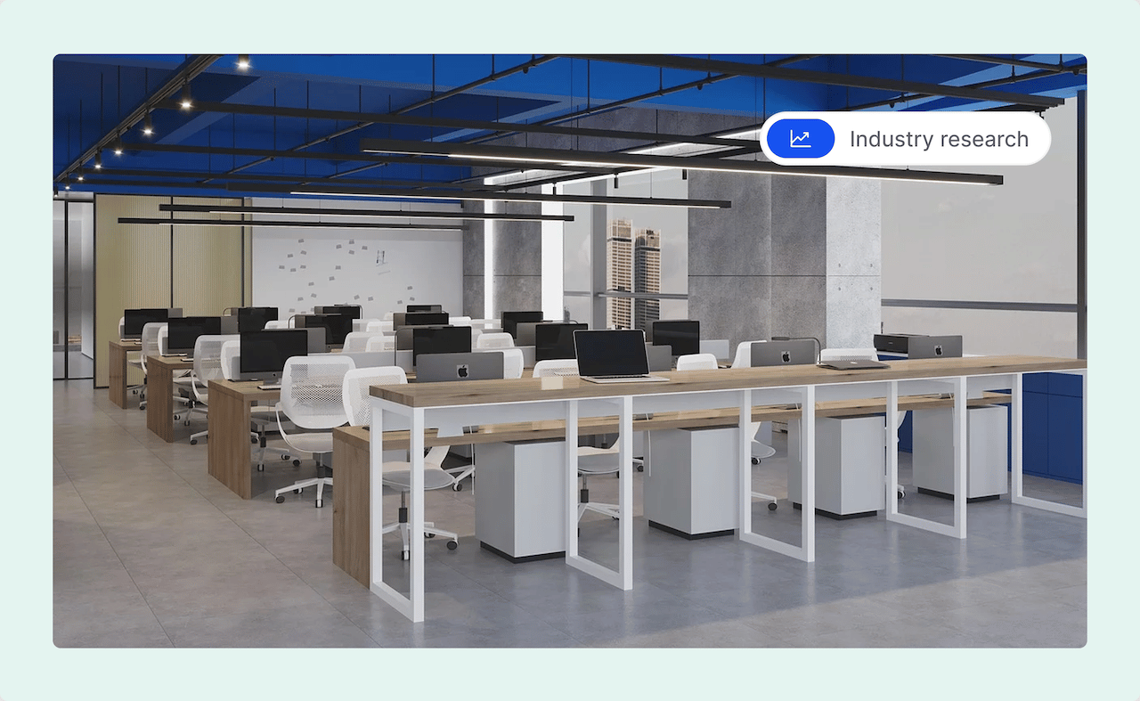 Modern open-plan office with rows of desks, white chairs, and desktop computers under a blue ceiling.