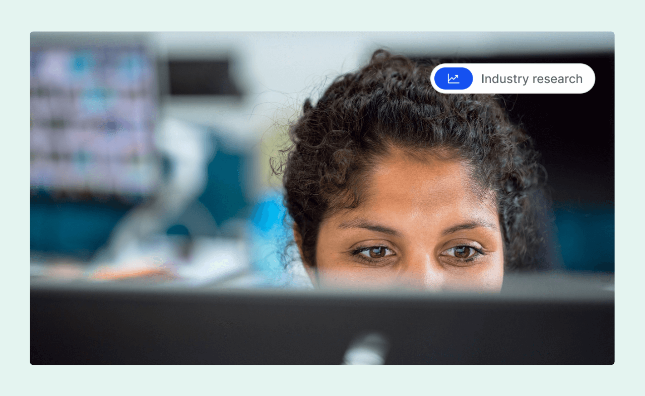 Close-up of a woman focused on her computer screen in an office setting.