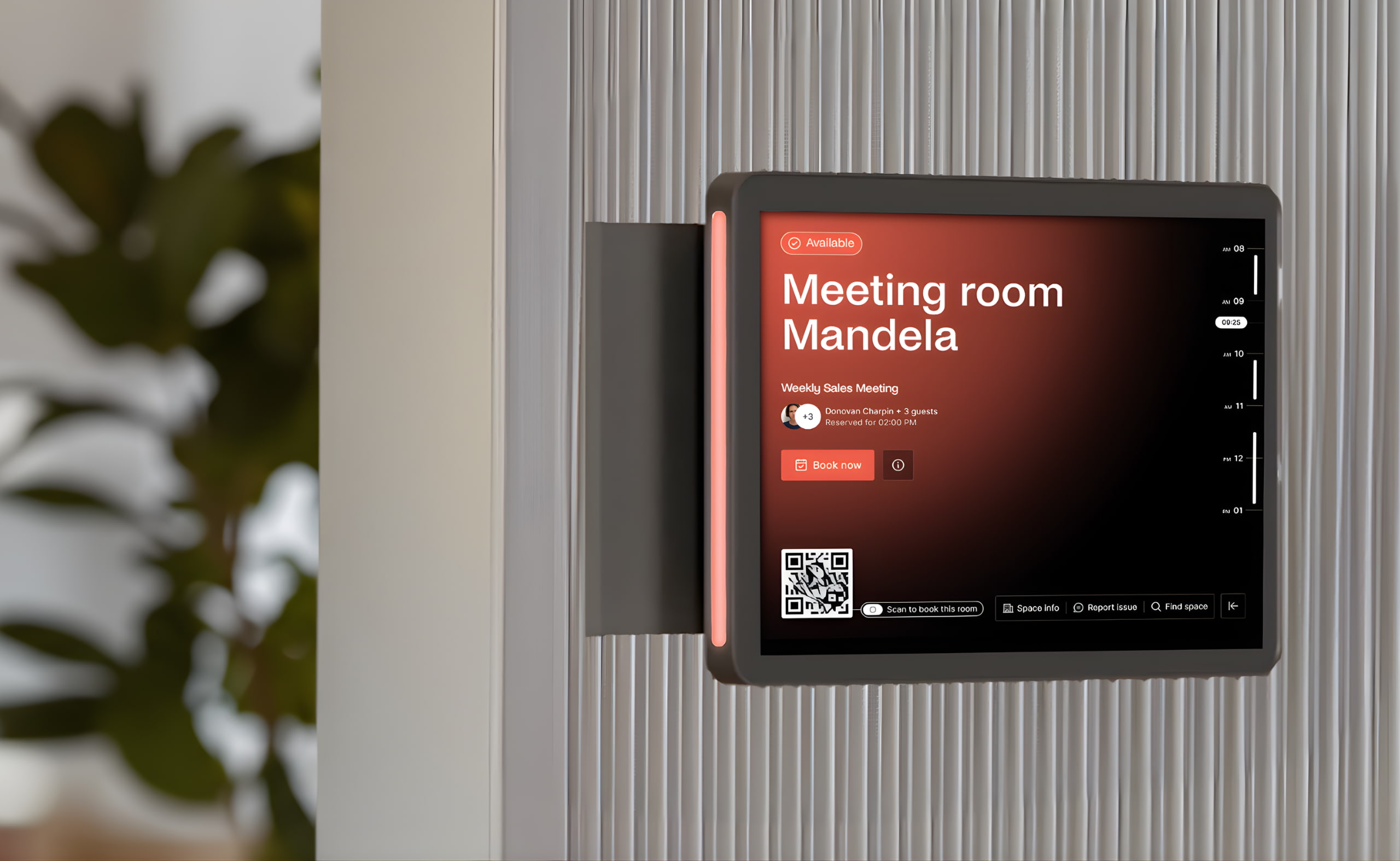 Wall-mounted meeting room display running Archie Rooms app, showing availability, schedule, and a QR code for room booking.