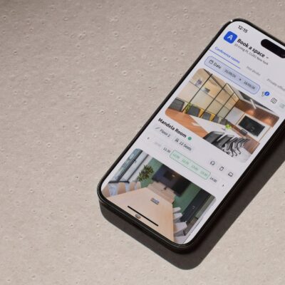 Archie meeting room booking app on a smartphone showing available conference rooms and time slots for reservations.