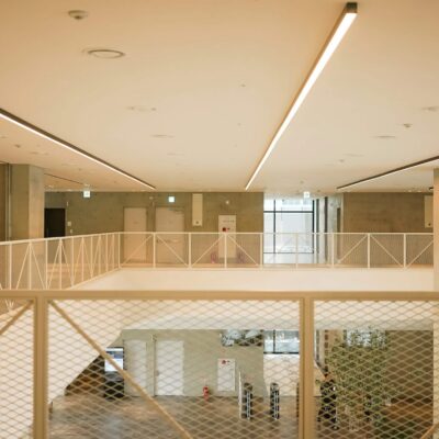 Modern office interior with open atrium, railings, and minimalist design.