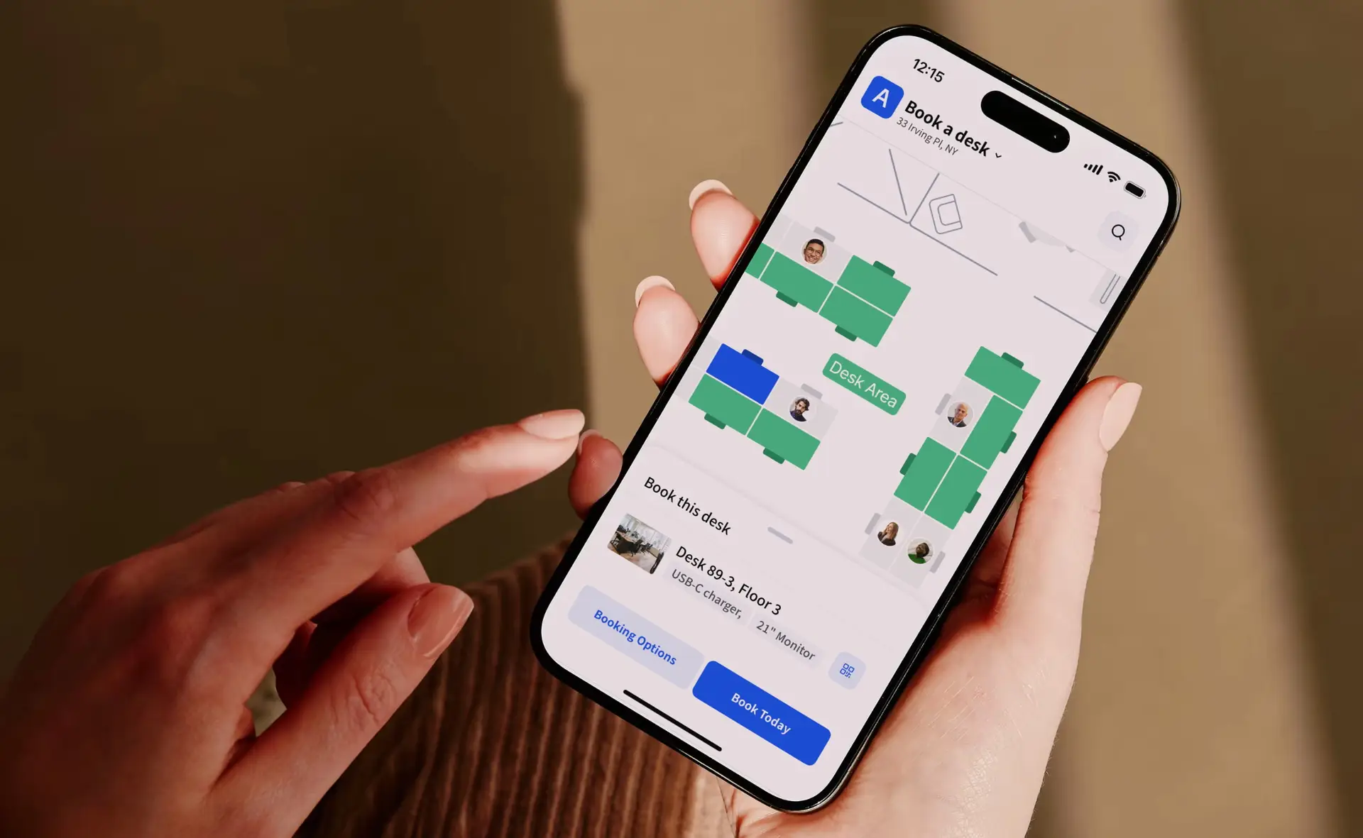 Person using Archie’s mobile desk booking app to reserve a workspace through an interactive office floor plan.